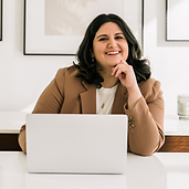 A woman sitting at a desk with a laptop.